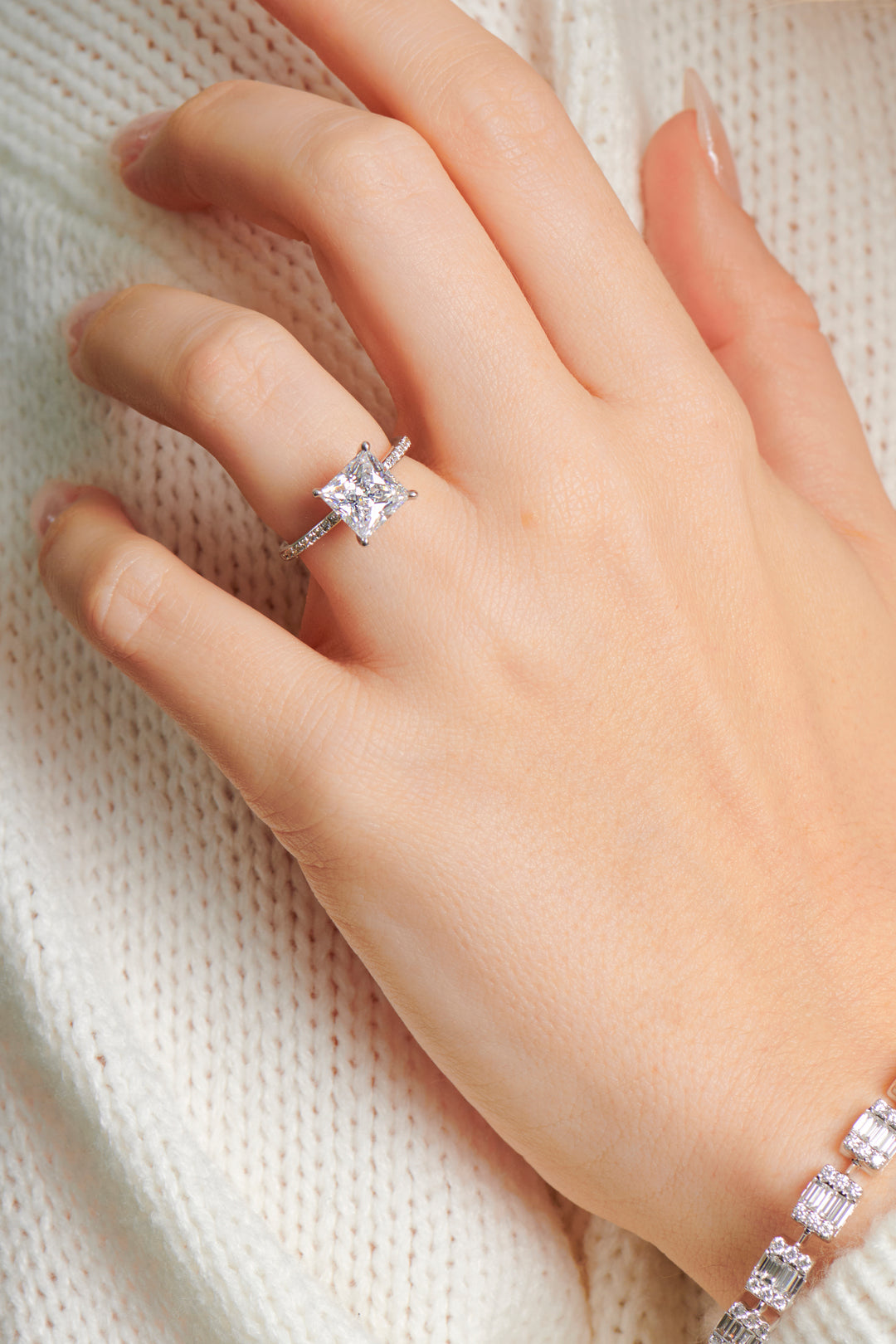 Lady wearing the Paige princess cut diamond engagement ring set in 4 claw