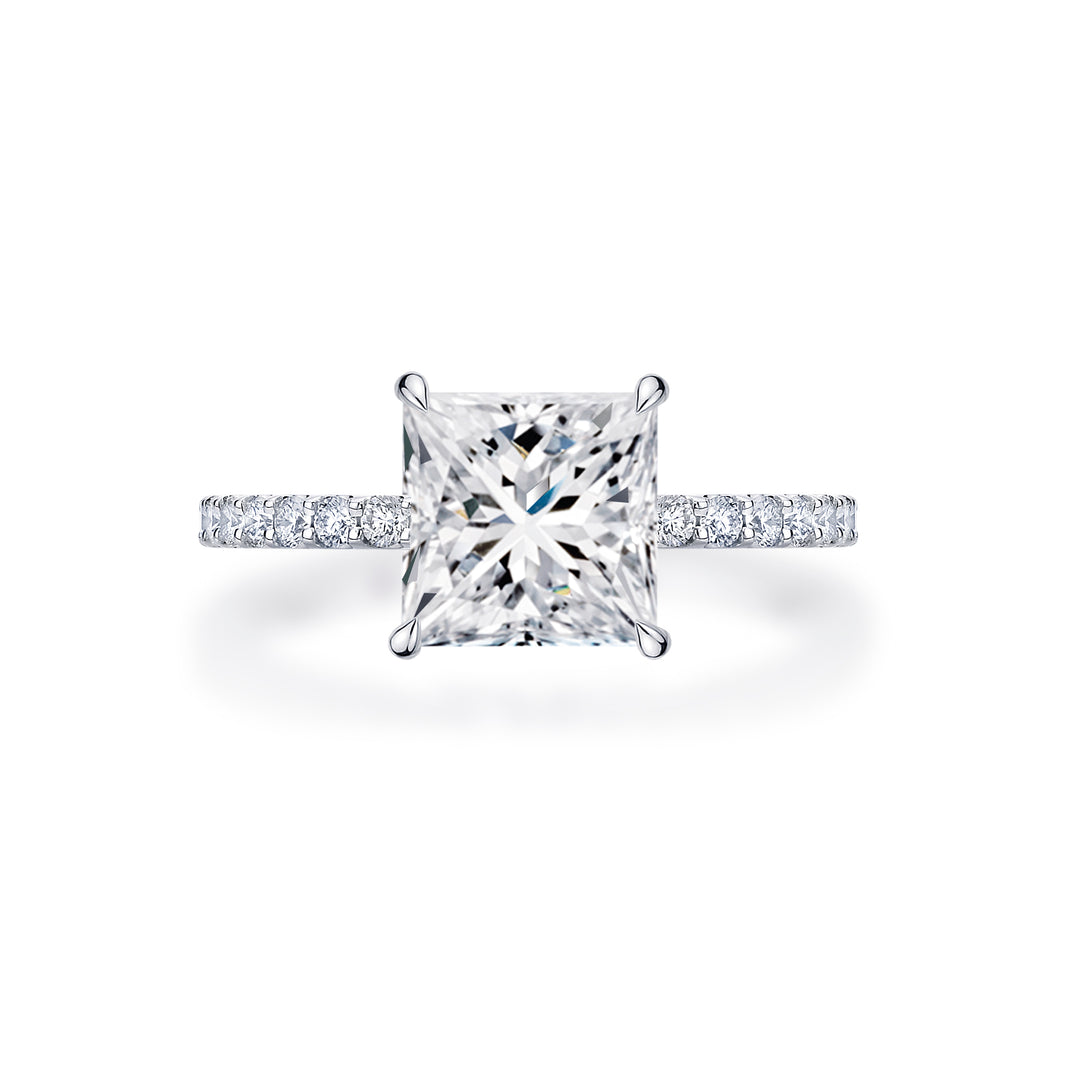 White gold princess cut diamond engagement ring set in 4 claws on a round brilliant cut band