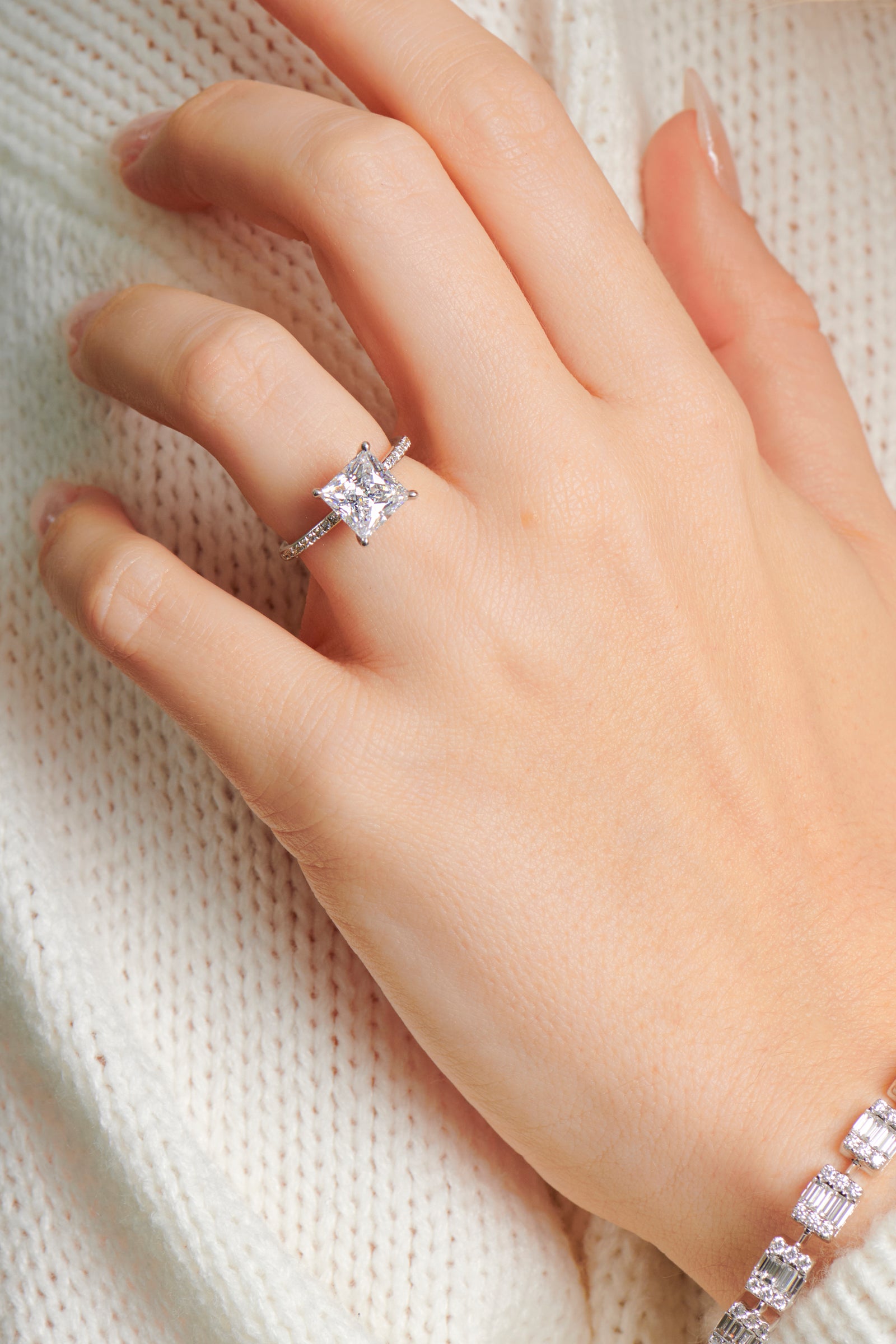 Lady wearing the Paige princess cut diamond engagement ring set in 4 claw
