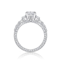 The Amelia princess cut engagement ring features Round brilliant cut diamonds grain set into each side, finished with millgrain detailing in a scalloped design