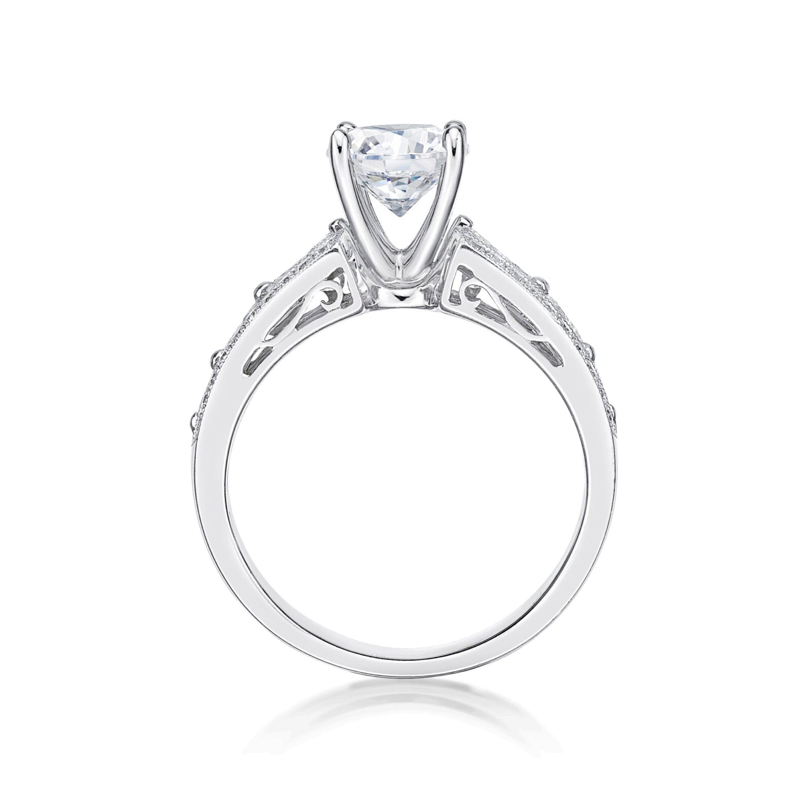 The Bijou features a round brilliant cut diamond centre adorned by princess cut diamonds single claw set into the shoulders of the band 